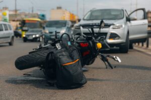 motorcycle laying on the street after car accident